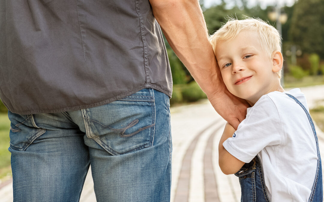 dad with physical custody of his child, who looks behind happily